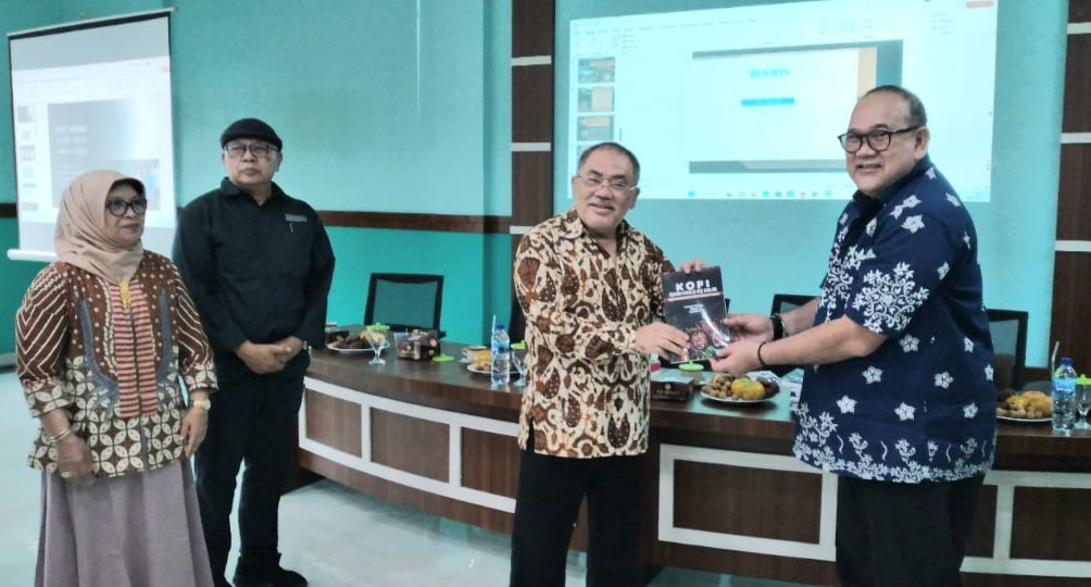 Ketua Prodi Doktor Ilmu Pertanian UMA Prof Ir Zulkarnain Lubis MS PhD menerima buku "Kopi Dari Hulu ke Hilir" dari Prof R Hamdani Harahap seusai diskusi panel tentang kopi pada launching Jo-TEC, di Kampus PPs UMA Jalan Sei Serayu Medan,